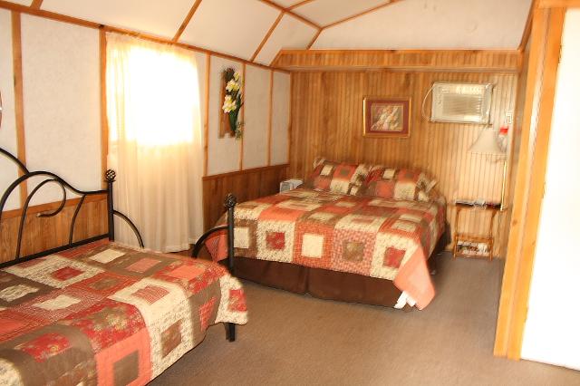 Bedroom Featuring Two Beds With A Bedside Table