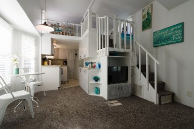 A Small Living Room Featuring Stairs Leading To An Upper Level