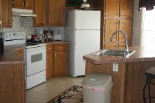 A Modern Kitchen Featuring A Refrigerator, Stove, And Microwave