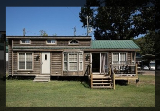 A Small Cabin Featuring A Porch And A Deck