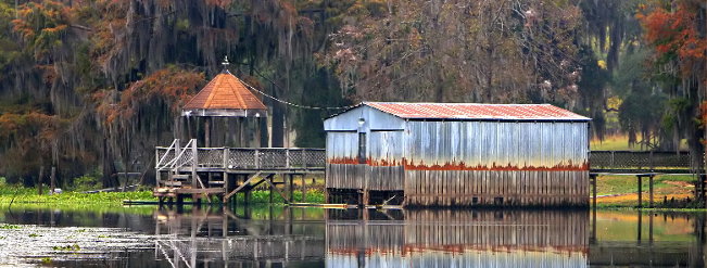 Wooden House Located At The Edge Of A Serene Lake