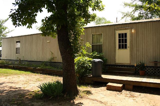 Small Trailer Home Featuring A Porch